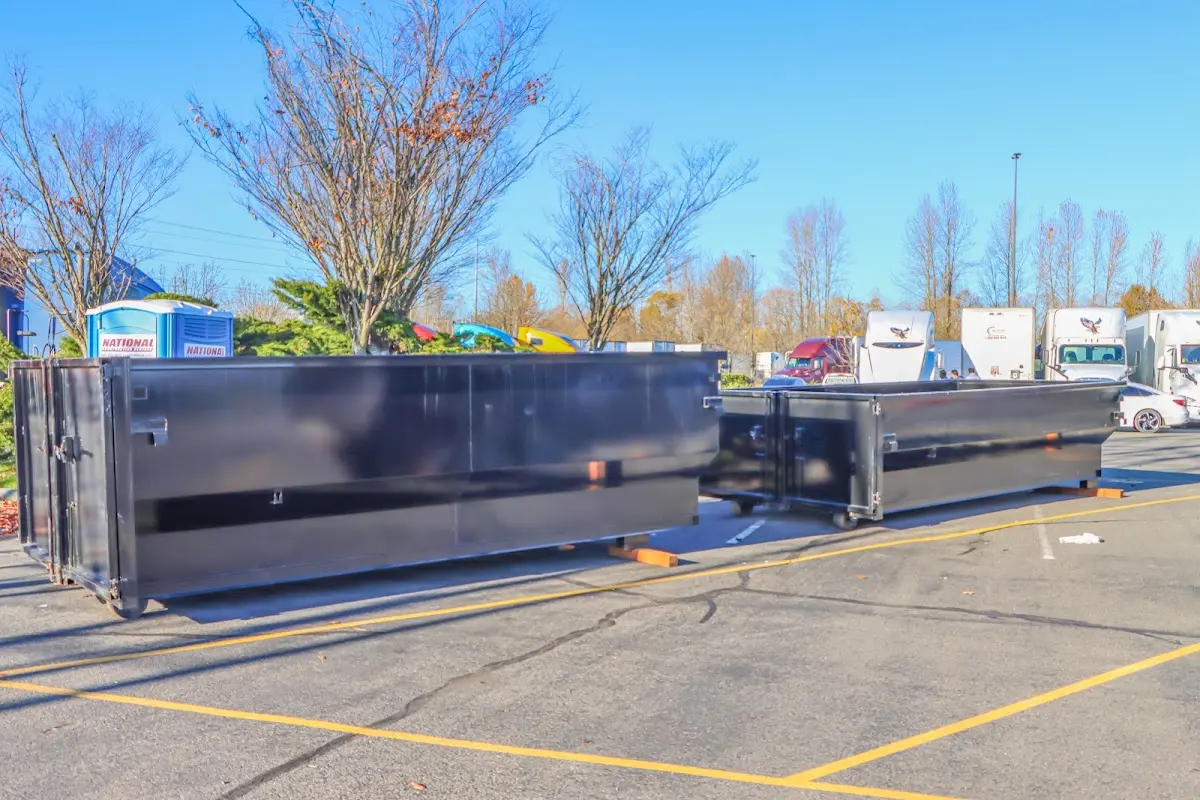 Professional dumpster rental service with roll-off container on residential driveway in Machesney Park